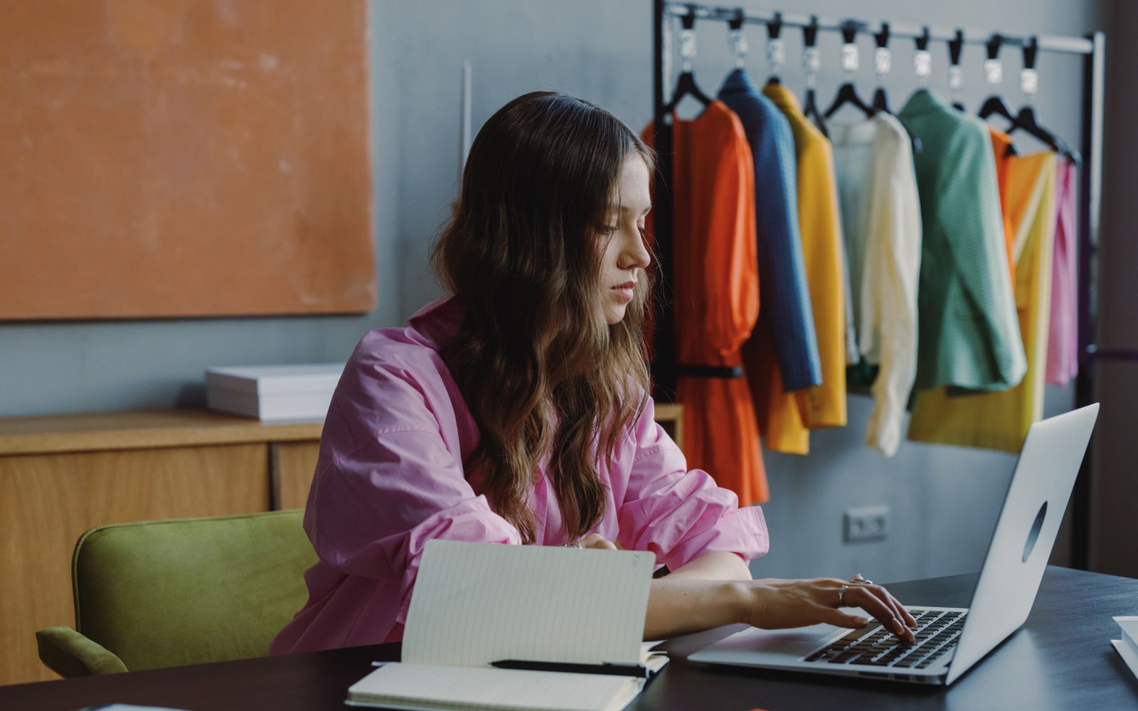 Marketing professional working at a laptop in an office