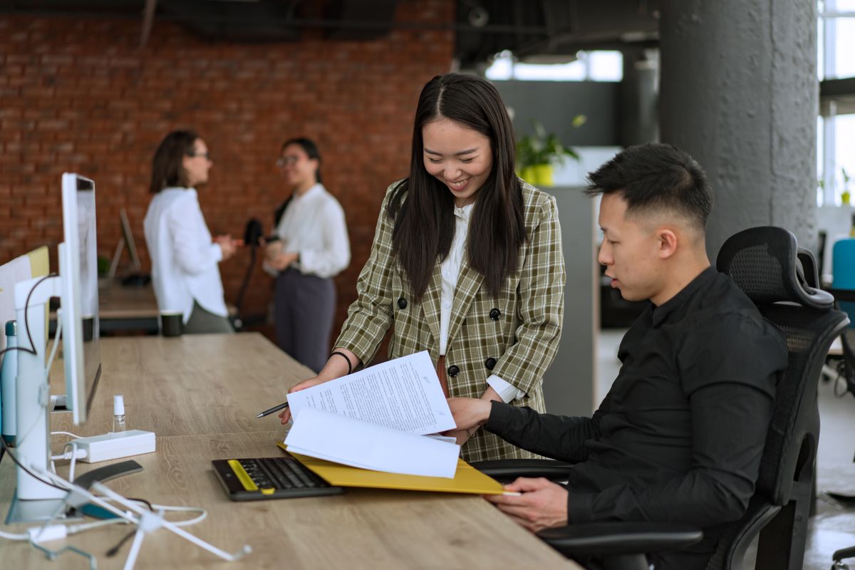 Colleagues reviewing paperwork at a desk